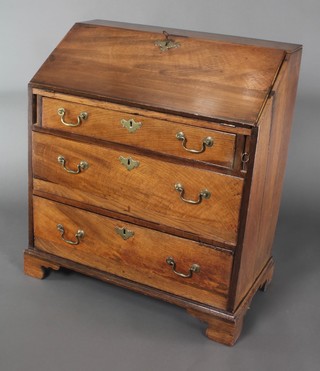 A Georgian oak bureau, the fall front revealing a well fitted interior above 3 long graduated drawers with brass swan neck drop handles 34"h x 30"w x 15"d 