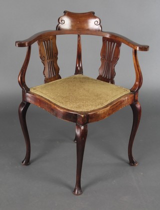 An Edwardian walnut corner chair with pierced slat back and upholstered seat, raised on cabriole supports