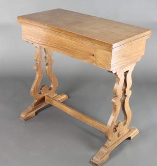 An Arts & Crafts light oak card table, raised on pierced lyre supports with H framed stretcher 30"h x 30"w x 15"d 