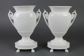 A pair of white glazed classical urn vases on claw feet 12" 