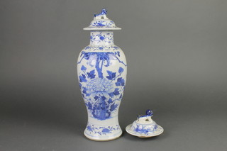 A late 19th Century Chinese blue and white oviform vase and lid decorated with flowering peony 15" 