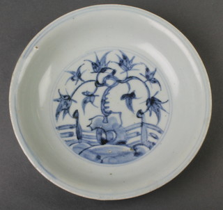 An 18th Century Chinese provincial shallow dish decorated with a panel of flowers, the outside with formal scrolling flowers 7 1/2" 