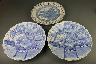 A pair of blue and white scallop dishes decorated with a garden scene 14", a Japanese ditto with pierced rim decorated with exotic birds 13" 