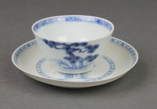A blue and white "Nanking Cargo" tea bowl and saucer, decorated with a band of geometric symbols, the saucer enclosing a tree duplicated on the tea bowl, together with a certificate of authenticity from Spink, bearing original lot number 5530 from the sale of the 20th April to the 2nd May 1986