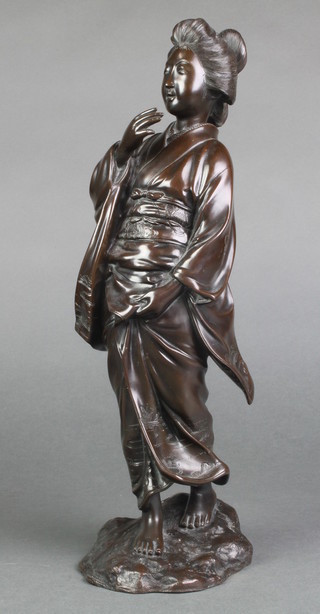 A good Meiji period bronze figure of a robed lady on a rocky base, the gown decorated with landscapes and flowers, signed, 14"h 
