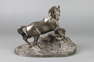 A bronze figure of a standing stallion by a tree stump, raised on an oval naturalistic base 7", the base marked SS 015