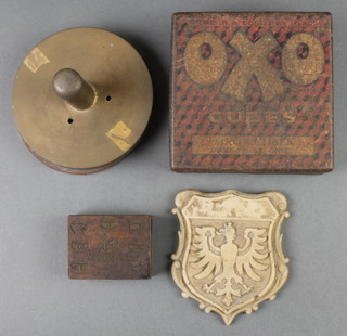 A Swan collar printing block decorated 7 different collars 2" x 2 1/2", a pressed metal stamp marked John Tiranti Ltd, a "Polish" shield shaped plaque 3" and an old Oxo tin 