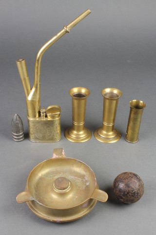 A brass opium pipe, a Trench Art ashtray formed from a 1916 4.5lb shell, 2 shell case vases 4 1/2", metal nose cone 2" and a 2" cannonball 