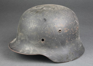 A German steel helmet, the interior impressed E123 (no liner) 