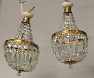 A pair of circular gilt metal and glass bag shaped light fittings 19" 