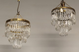 A pair of circular gilt metal 3 tier drop light fittings hung lustres 10"