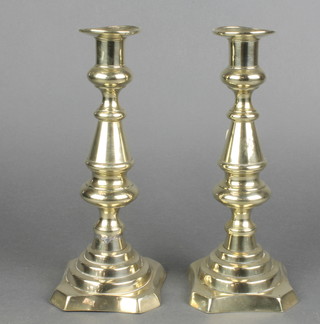 A pair of 19th Century brass candlesticks with ejectors 10"h 