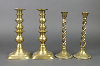 A pair of 19th Century brass candlesticks 9 1/2" together with a pair of brass spiral turned candlesticks 9 1/2" 