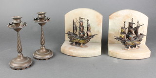 A pair of Art Deco marble and gilt metal bookends decorated galleons 6" together with a pair of bronze candlesticks with castellated sconces 6"  
