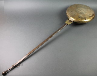 A 17th/18th Century brass warming pan the pierced and engraved lid with 3 marks and with a polished steel handle
