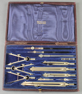A 13 piece geometry set contained in a red leather case 
