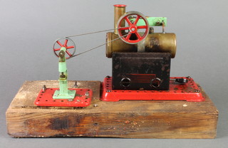A Mamod stationary steam engine, raised on a rectangular oak base 