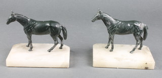 A pair of spelter and white metal bookends in the form of standing horses, raised on rectangular white marble bases 3" 