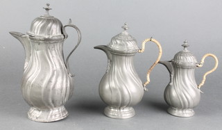 2 baluster shaped pewter hot water jugs of swirl form, the bases marked Engl Block Finn 7" and 6 1/2" and 1 other 8" 