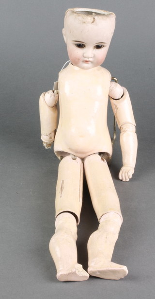 A porcelain headed doll with open eyes and open mouth with teeth,with articulated limbs, the body 15"
