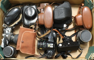 An Olympus OM101 camera, a canon AV-1 camera with Canon lens FD50mm 1:1.8 lens, a Pentax MTL3 camera with multi coating lens 8.1/50, a Yashica Lynx 1000 camera, a Yashica Minster together with 4 other cameras and a Sigma 1:3.8 lens 