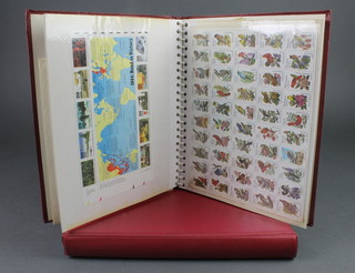 An album of mint GB stamps and first day covers together with an album of American mint and presentation stamps 