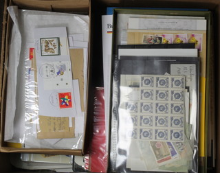 A quantity of used world stamps contained in a cardboard box 