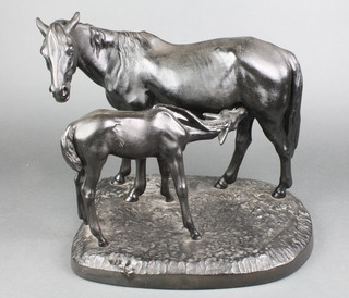 After Kacnh, a bronzed iron figure group of a standing mare and suckling foal, raised on an oval base 14", the base marked Kacnh 1968 Casnahob CCC D33 