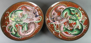 A pair of 19th Century Japanese cloisonne enamelled chargers decorated dragons 14" diam. 