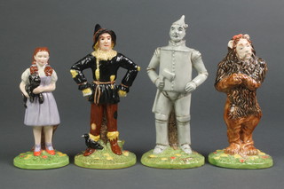 4 Royal Doulton figures from the Wizard of Oz - Dorothy 5 1/2", Scarecrow 6 1/4", Lion 6" and Tin Man 7" 