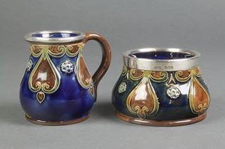 A Royal Doulton blue ground jug with geometric decoration having a silver lip, a matching sugar bowl 