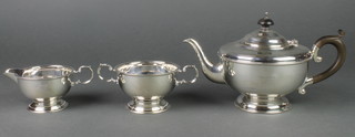 A silver 3 piece tea set with fruitwood handles and beaded decoration, Birmingham 1931, 648 grams gross
