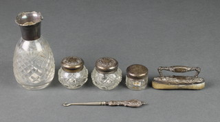 A repousse silver nail buffer, 4 lidded items and a button hook