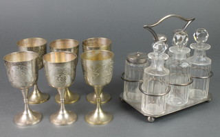 An Edwardian silver plated 6 bottle cruet stand and 6 plated gobles
