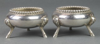 A pair of Victorian silver squat table salts with beaded rim and hoof feet, London 1865, 186 grams