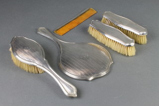 An engine turned silver backed 5 piece brush set with chased monogram Birmingham 1926 