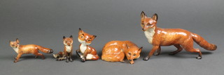 A Beswick figure of a standing fox 9 1/2", a ditto of a reclining fox 4 1/2", a small standing ditto 4 1/2", a seated ditto 3 1/2" and another 3 1/2" 