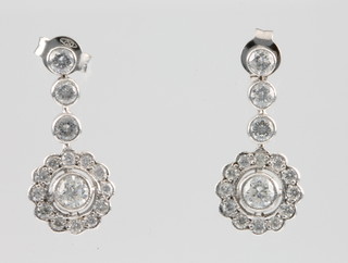 A pair of 18ct white gold diamond cluster earrings, suspended by 3 brilliants 1.5ct 