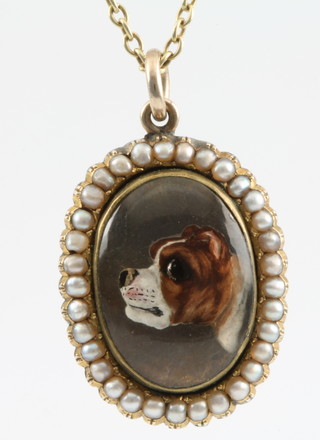 A Victorian gold and seed pearl set reverse crystal intaglio pendant (ex brooch) in the form of a bulldog on a pearl set chain 