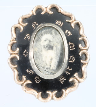 A Victorian in memorium enamelled gilt brooch with vacant locket 