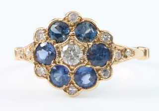 A yellow gold sapphire and diamond cluster ring with 6 brilliant cut sapphires surrounded by 11 brilliant cut diamonds, size M