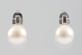 A pair of 18ct white gold cultured pearl and baguette diamond drop ear studs 