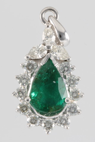 An 18ct white gold pear shaped emerald and diamond pendant, the emerald approx. 1.41ct surrounded by 14 diamonds 0.75ct 