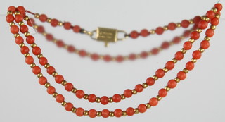 A Victorian coral necklace with an 18ct gold clasp and a matching 2 stone ring