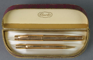 A boxed gold plated engine turned Onoto fountain pen and propelling pencil