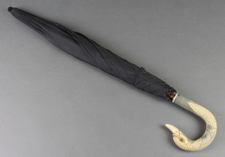 An early 20th Century composition parasol with duck head handle