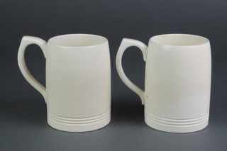 A pair of Keith Murray cream glazed Wedgwood mugs with ribbed decoration 5" 