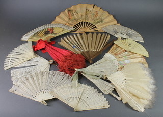 An Edwardian red silk parasol with a carved bone handle, 11 Edwardian and later fans 