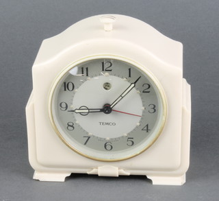 A Temco Art Deco electric alarm clock contained in an arched white Bakelite case 