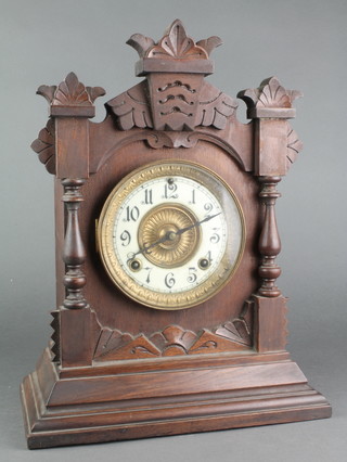 An Ansonia striking mantel clock with enamelled dial and Arabic numerals contained in a pine case 